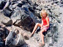 Summer sitting on the sharp shiny black obsidian